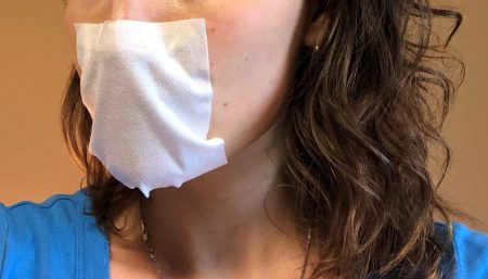 Strapless face mask held in place with removable medical adhesive