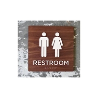 ADA-compliant, restroom sign measures 12", features Grade 2 Braille lettering...
