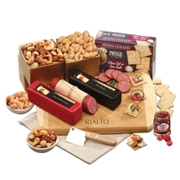 Cutting board with cheese, sausage, crackers, and other food items.... from...