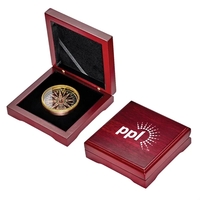 Multi-color desk compass measuring 2" in diameter and sitting inside of......