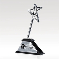 A shining chrome finished star pirouettes atop a black marble base... from...