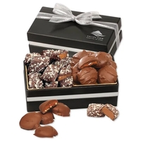 black and silver box filled with caramel pecan clusters and English... from...