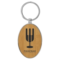 3" x 1 3/4" bamboo PU leatherette/metal oval keychain with metal... from ASI...