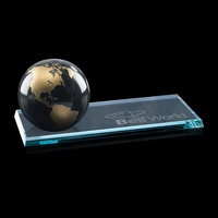 A Black Marble Globe, with the continents color-filled in gold, on... from...