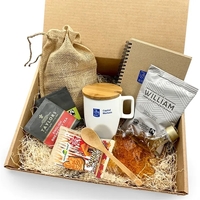 A cozy gift set with mug, maple syrup, cookies, journal, and... from ASI...
