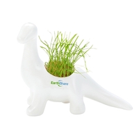 Dinosaur shaped planter made of ceramic and pre-loaded with seeded soil......