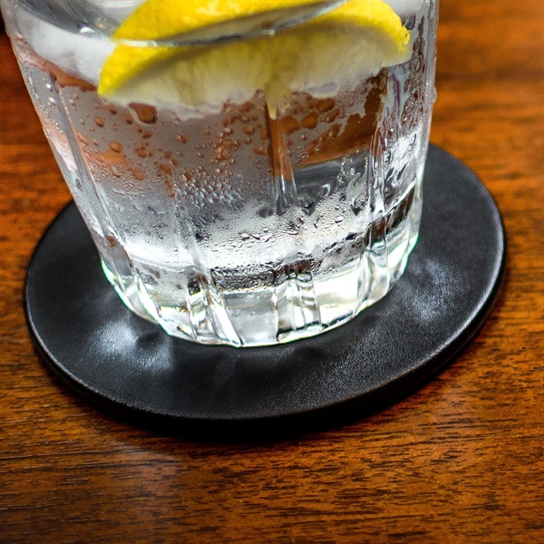 Black coaster made of leatherette with a protective felt bottom.... from ASI 48125 Dacasso / DaCasso