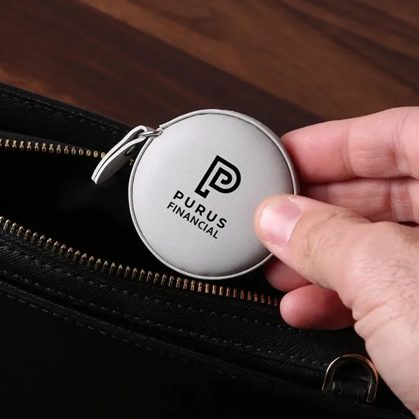 A vegan leather 5" tape measure featuring a dual-sided 60" tape... from ASI 61966 HPG / Beacon Promotions