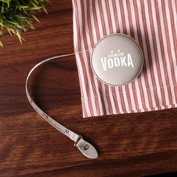A vegan leather 5" tape measure featuring a dual-sided 60" tape... from ASI 61966 HPG / Beacon Promotions