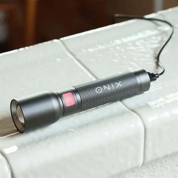 A rechargeable flashlight with case, offers a secure grip, powerful illumination,... from ASI 61966 HPG / Beacon Promotions