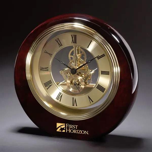 Polished rosewood desktop clock with Roman numerals, second hand and inner-workings... from ASI 68507 The Magnet Group / Benchmark Crystal & Clocks