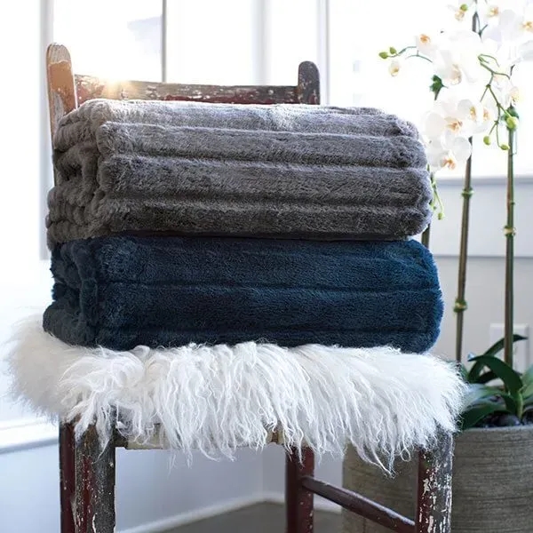 Rich faux leather throw blanket measuring 50" x 60"... from ASI 73520 Neet Feet / Kanata Blanket