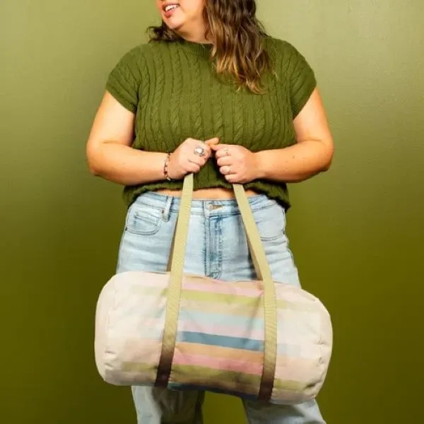 A canvas, barrel body Darling Duffel. It has a huge imprint... from ASI 74710 Numo