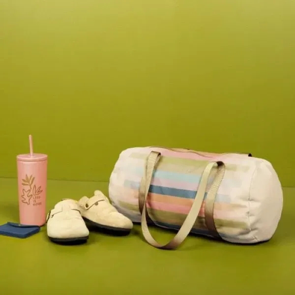 A canvas, barrel body Darling Duffel. It has a huge imprint... from ASI 74710 Numo