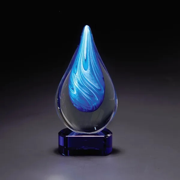 Clear glass decorative piece with bright blue swirling ribbons and blue... from ASI 68507 The Magnet Group / Benchmark Crystal & Clocks