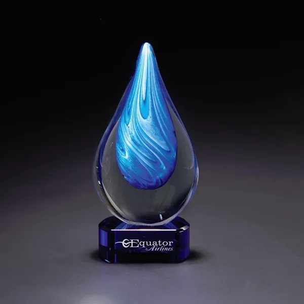 Clear glass decorative piece with bright blue swirling ribbons and blue... from ASI 68507 The Magnet Group / Benchmark Crystal & Clocks