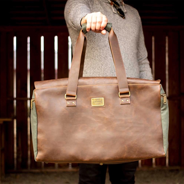 Leather duffle comes with handles, shoulder strap, 35-liter capacity, secure zippered... from ASI 61966 HPG / OrigAudio