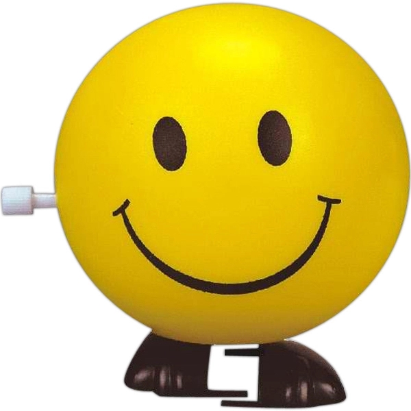 Round happy face design yellow wind-up toy with black markings.... from ASI 31977 Adline Industries Inc
